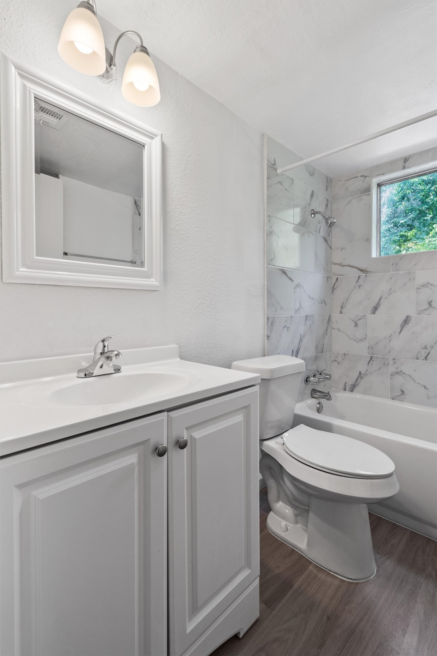 2501 Manor Circle, Unit B Austin, TX 78723 - Photo 15 of 17 a bathroom with a toilet a sink a mirror and vanity