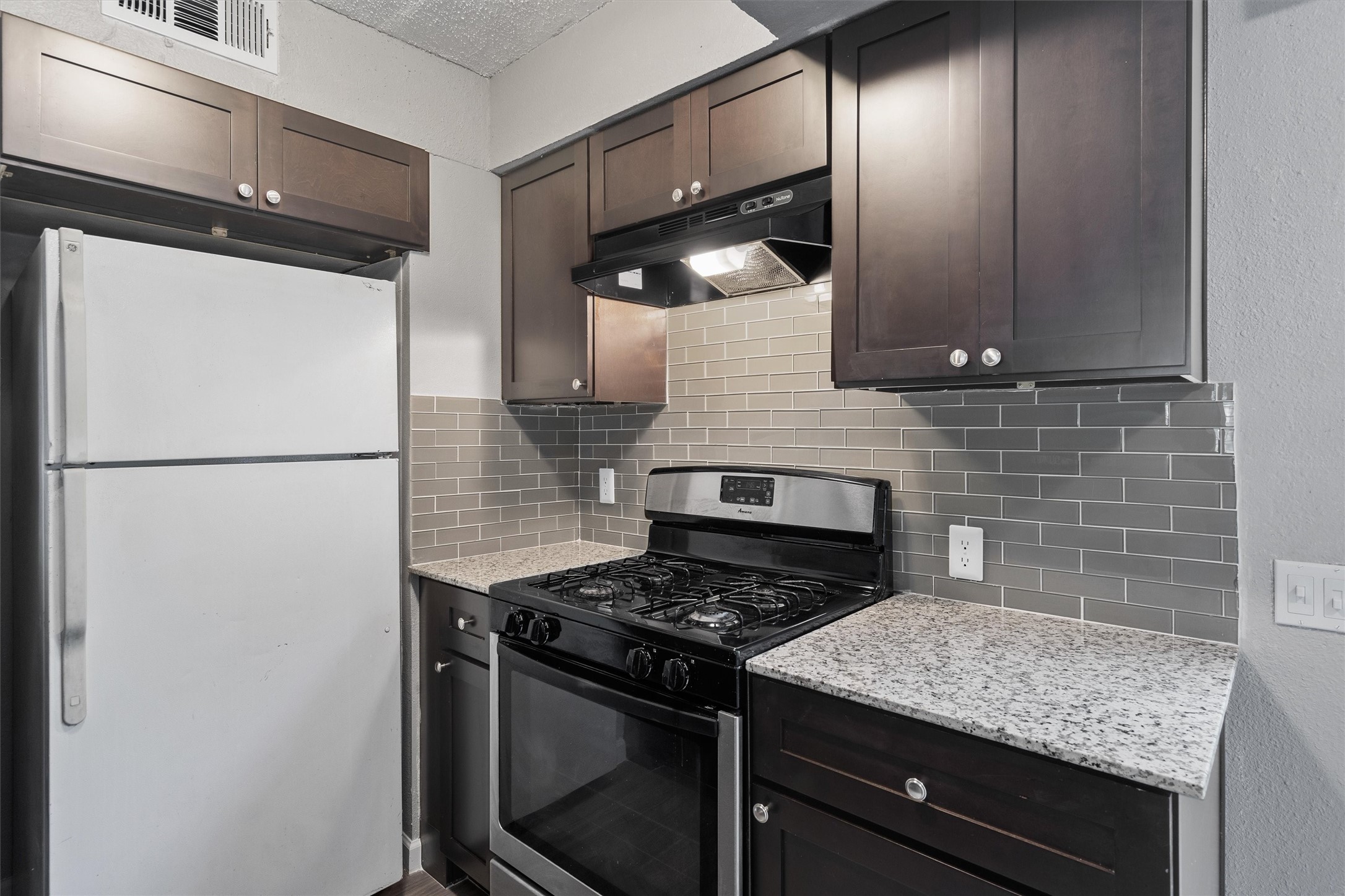 2501 Manor Circle, Unit B Austin, TX 78723 - Photo 8 of 17 a kitchen with a stove and a refrigerator