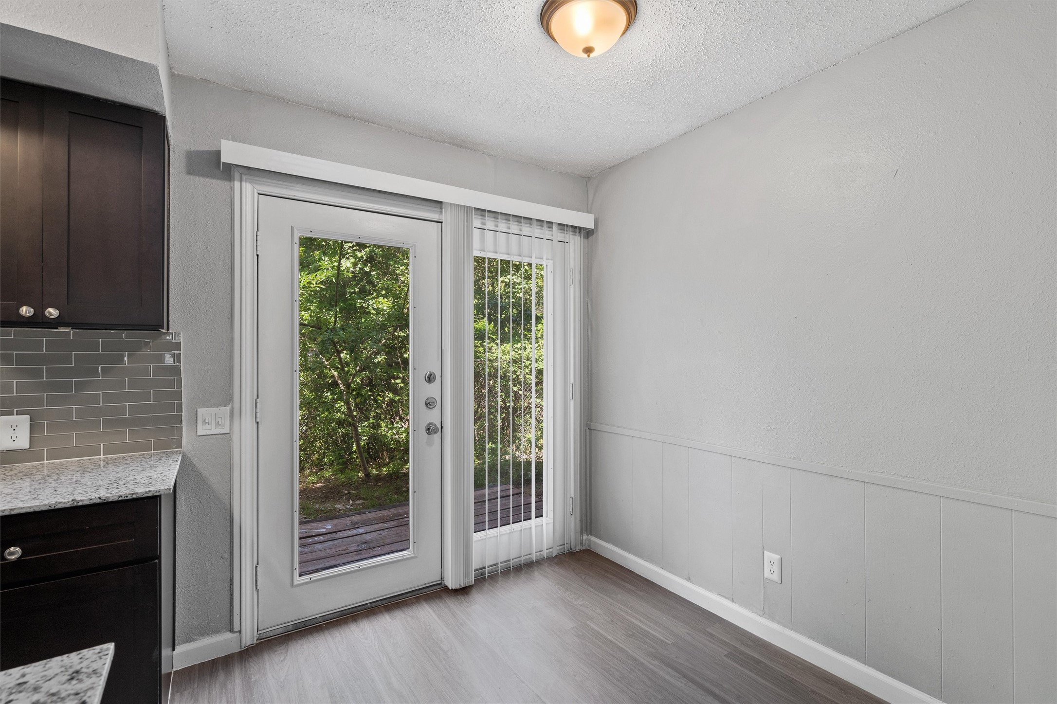 2501 Manor Circle, Unit B Austin, TX 78723 - Photo 9 of 17 a view of an empty room with wooden floor and a window