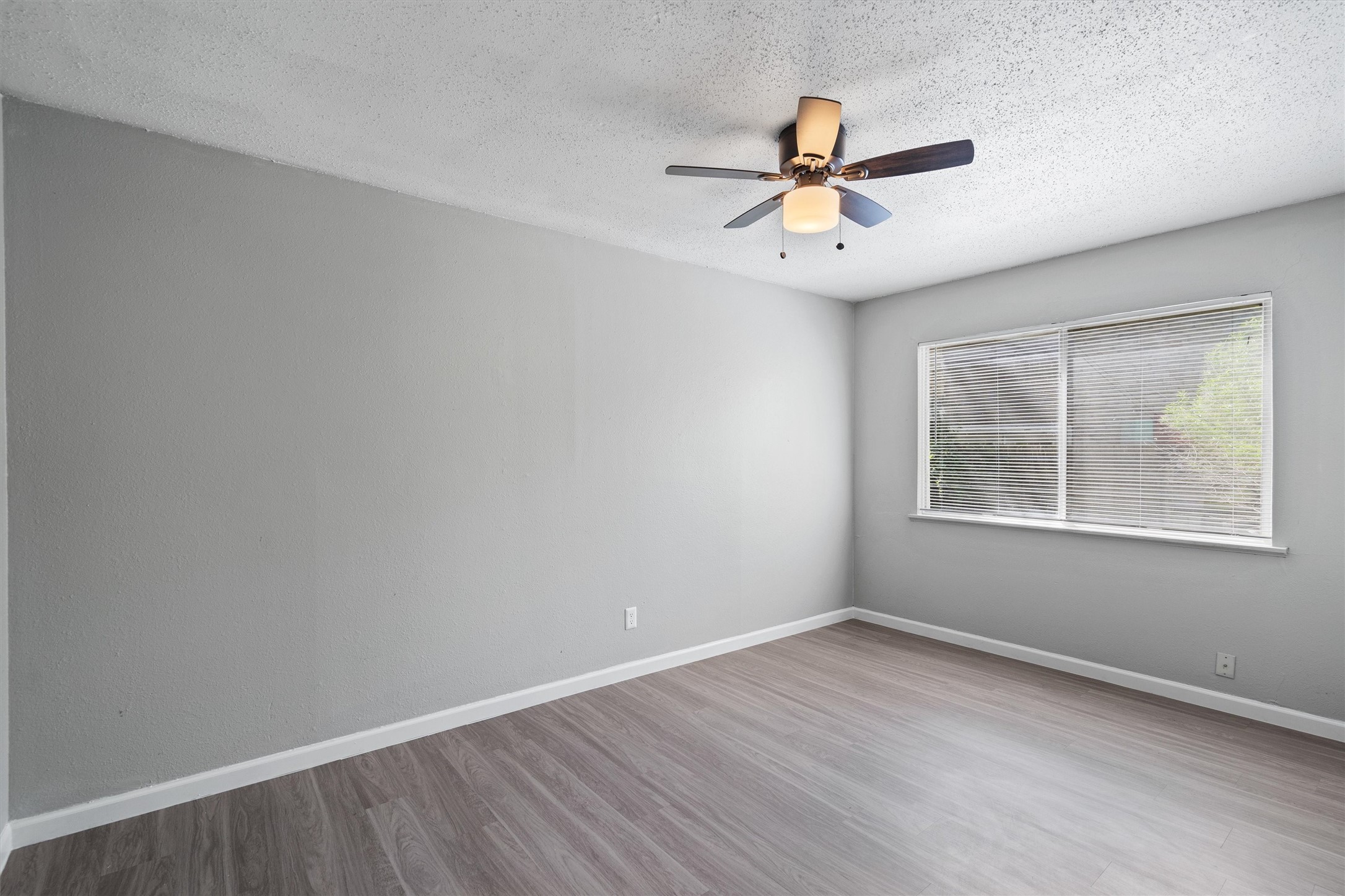 2501 Manor Circle, Unit B Austin, TX 78723 - Photo 10 of 17 wooden floor in an empty room with a window
