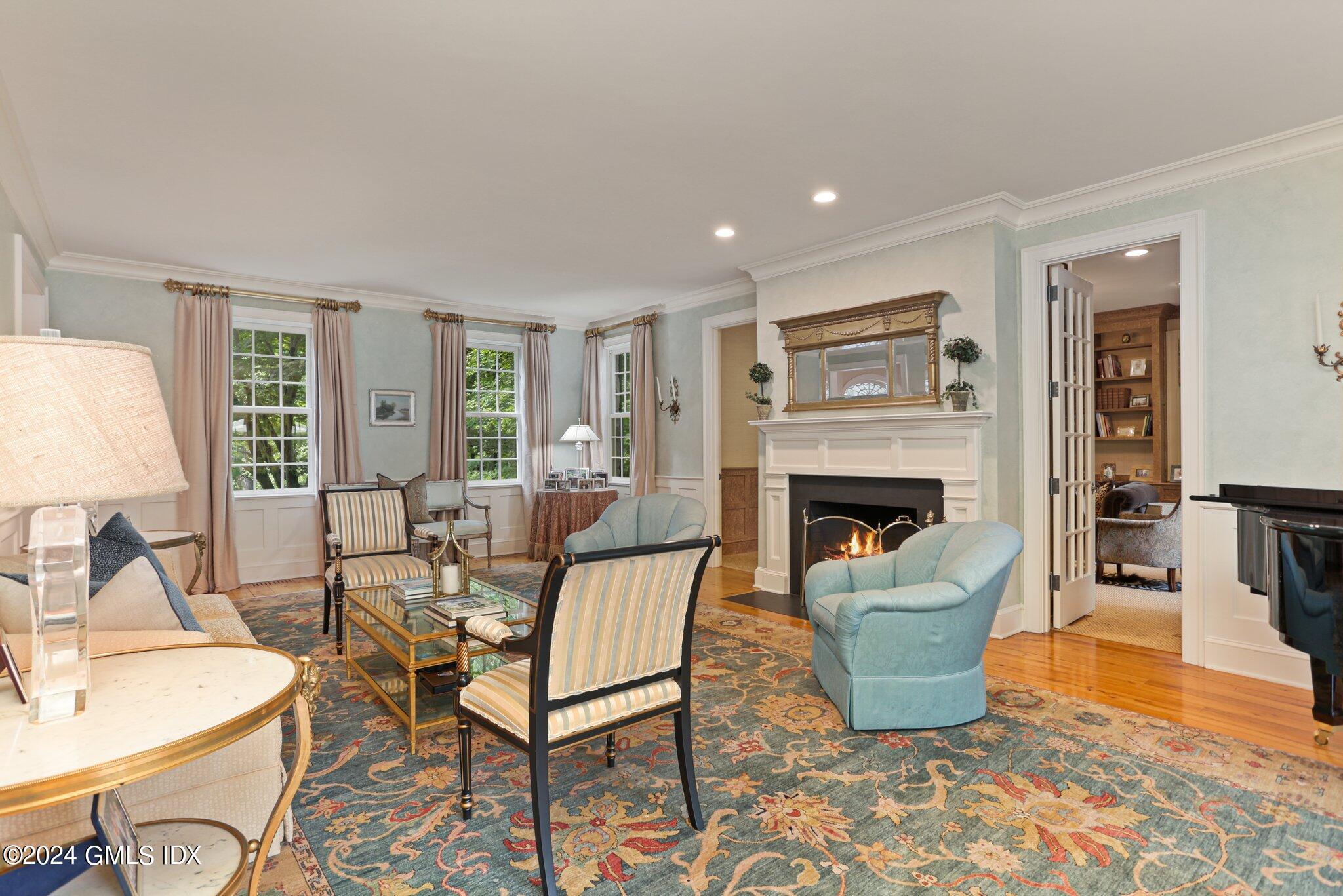 68 Rock Maple Road Greenwich, CT 06830 - Photo 11 of 46 a living room with furniture a fireplace and a table