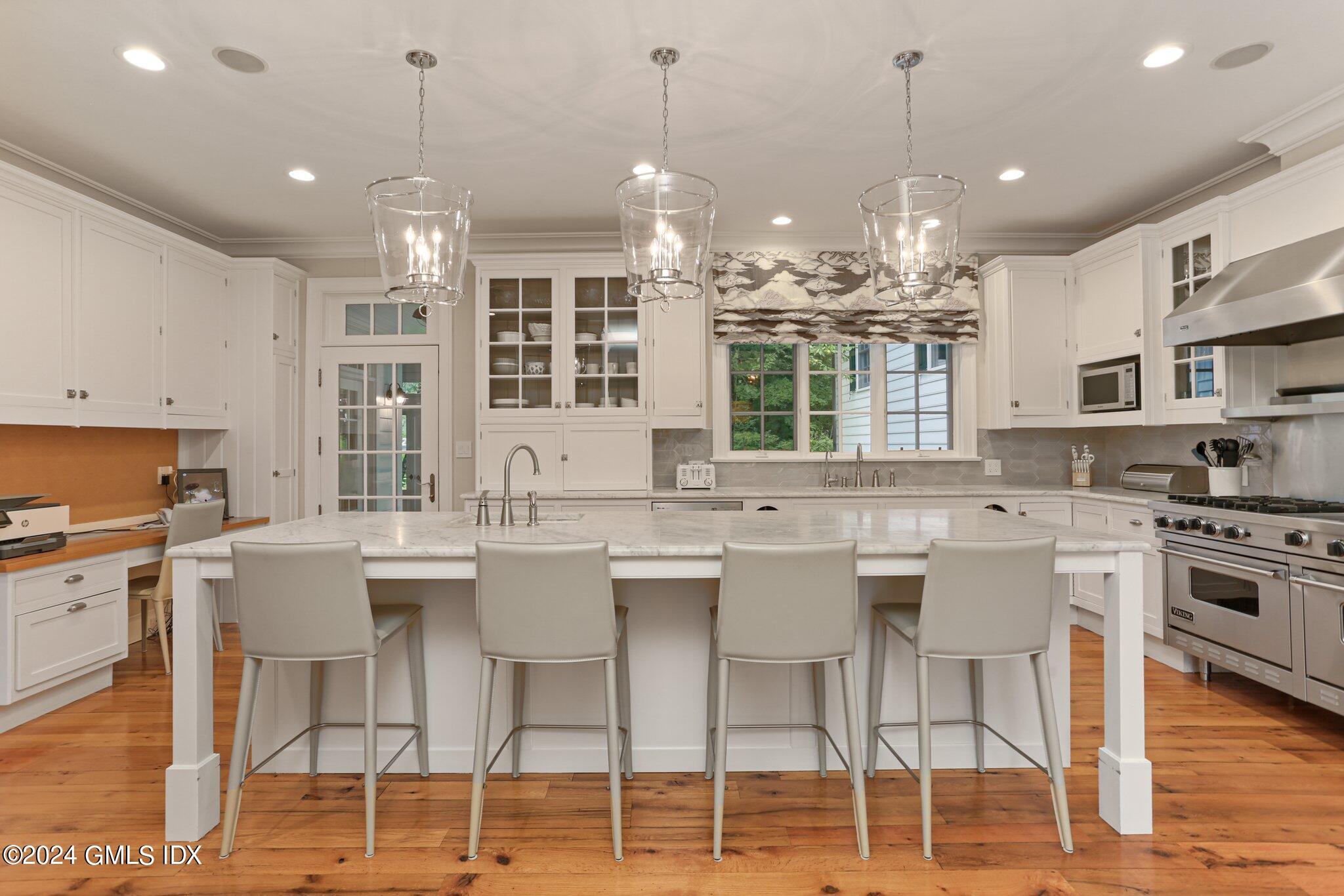 68 Rock Maple Road Greenwich, CT 06830 - Photo 14 of 46 a kitchen with stainless steel appliances granite countertop a sink a stove a refrigerator cabinets and chairs