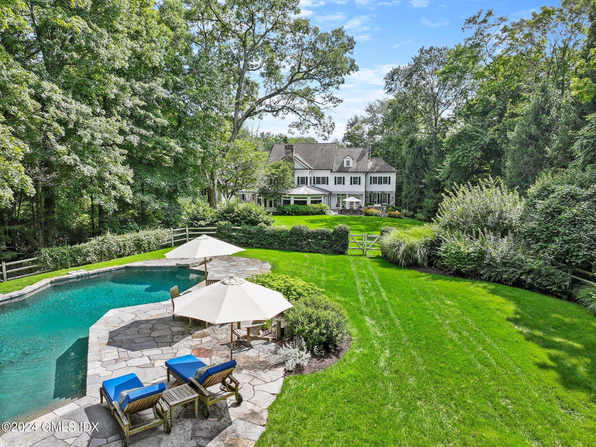 68 Rock Maple Road Greenwich, CT 06830 - Photo 2 of 46 a view of a house with a yard and furniture