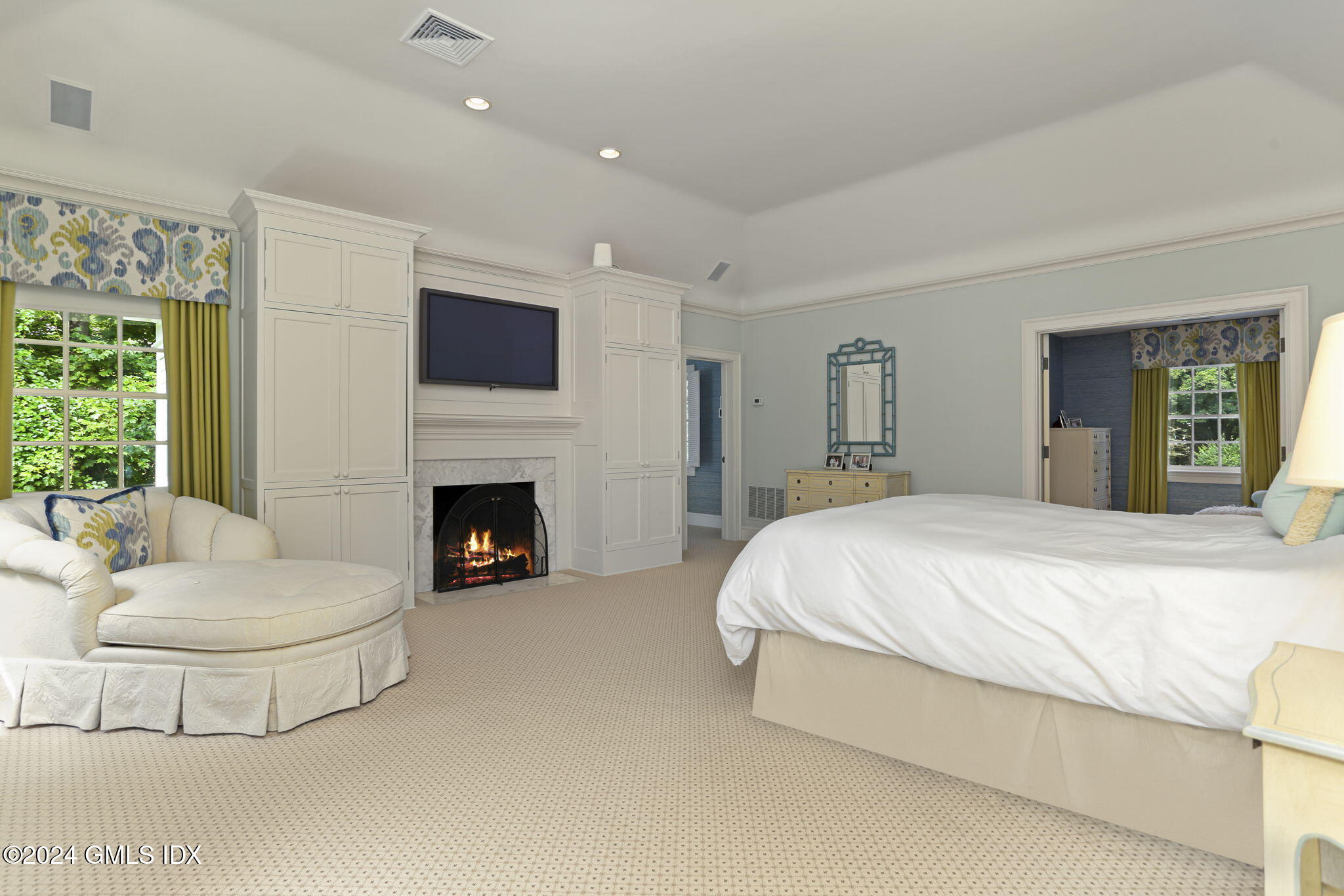 68 Rock Maple Road Greenwich, CT 06830 - Photo 21 of 46 a spacious bedroom with a bed and a fireplace