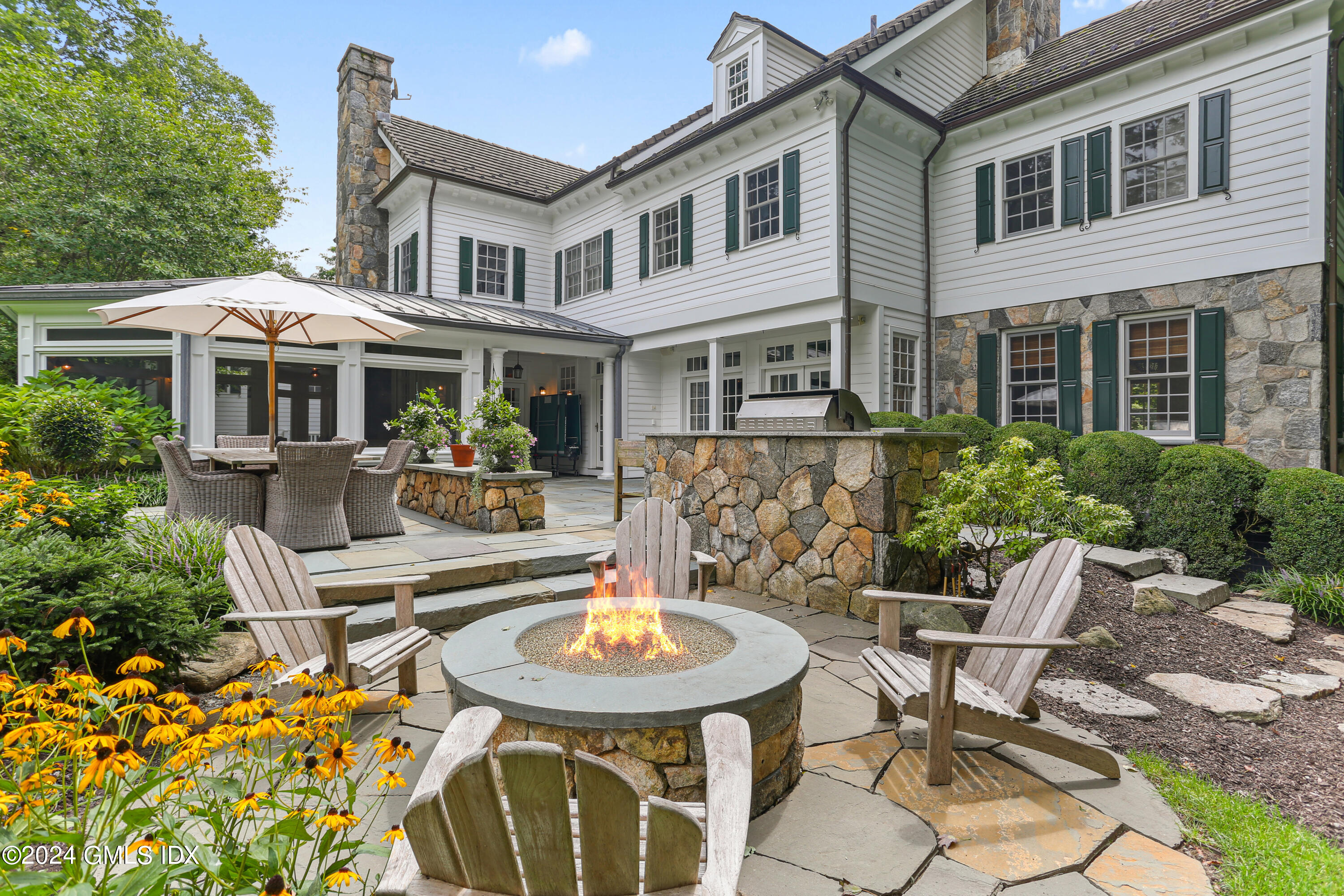 68 Rock Maple Road Greenwich, CT 06830 - Photo 3 of 46 a view of a patio with table and chairs and potted plants
