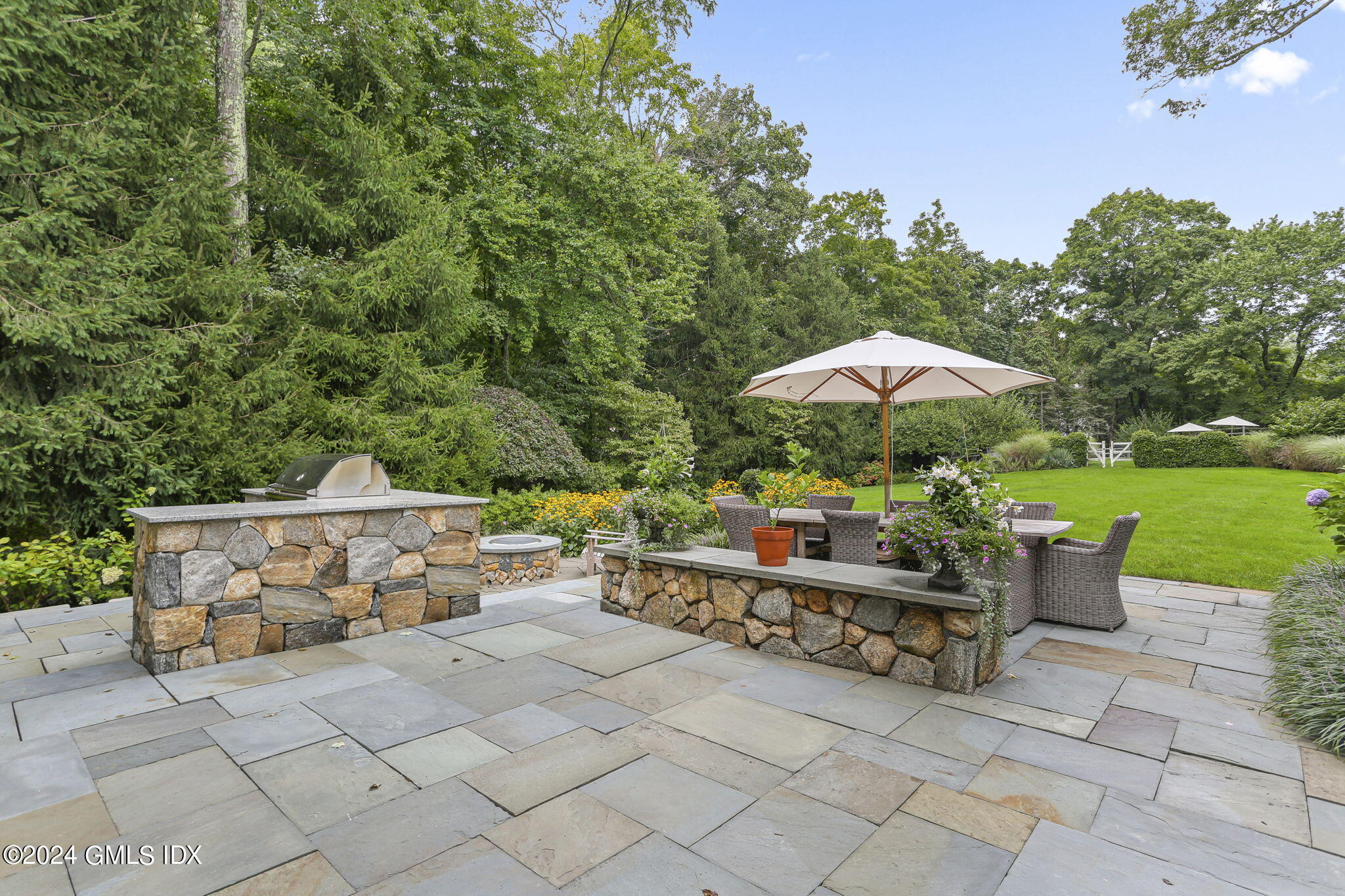 68 Rock Maple Road Greenwich, CT 06830 - Photo 37 of 46 a view of house with patio outdoor seating