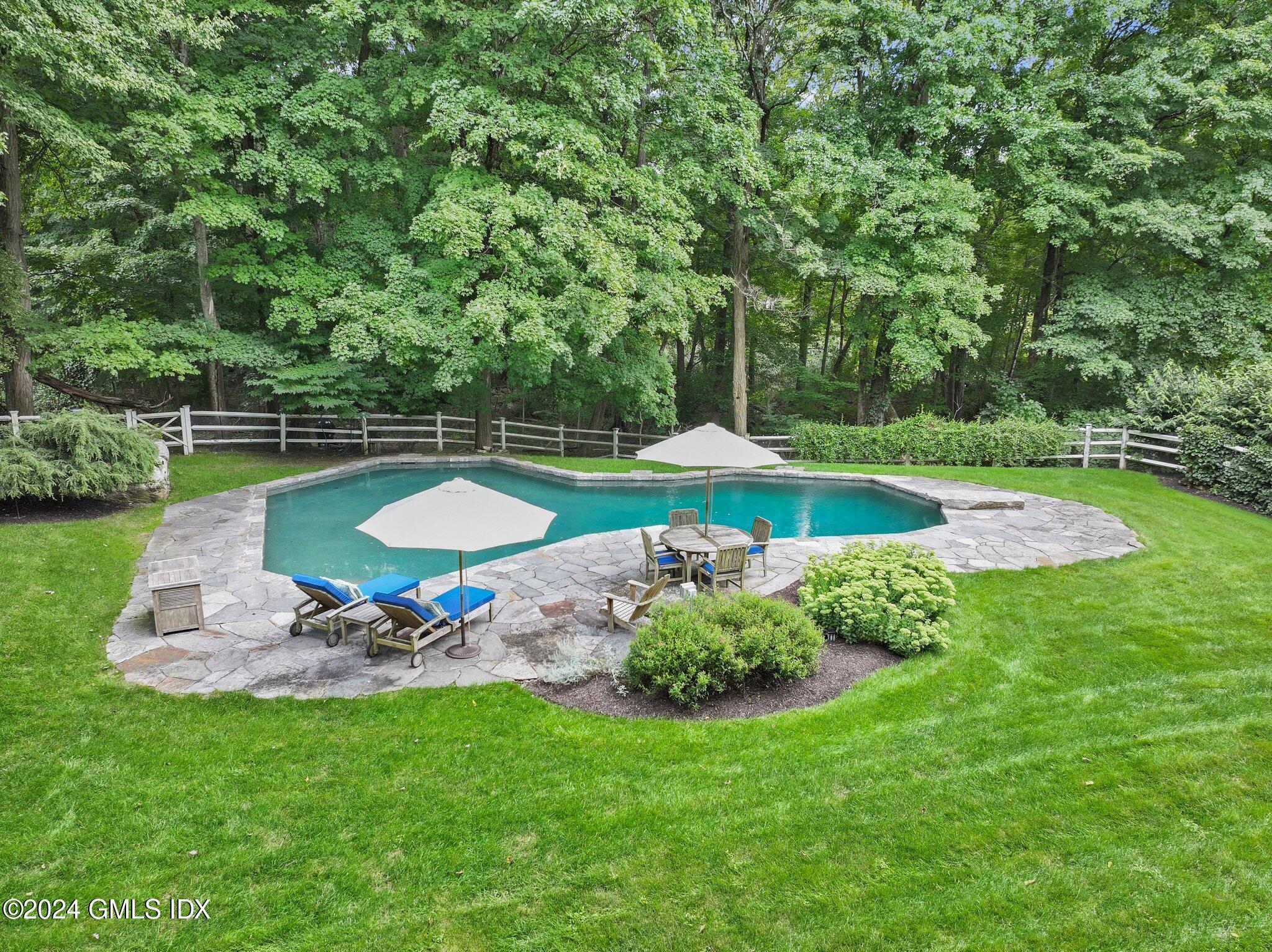 68 Rock Maple Road Greenwich, CT 06830 - Photo 38 of 46 a view of a table and chairs in the garden