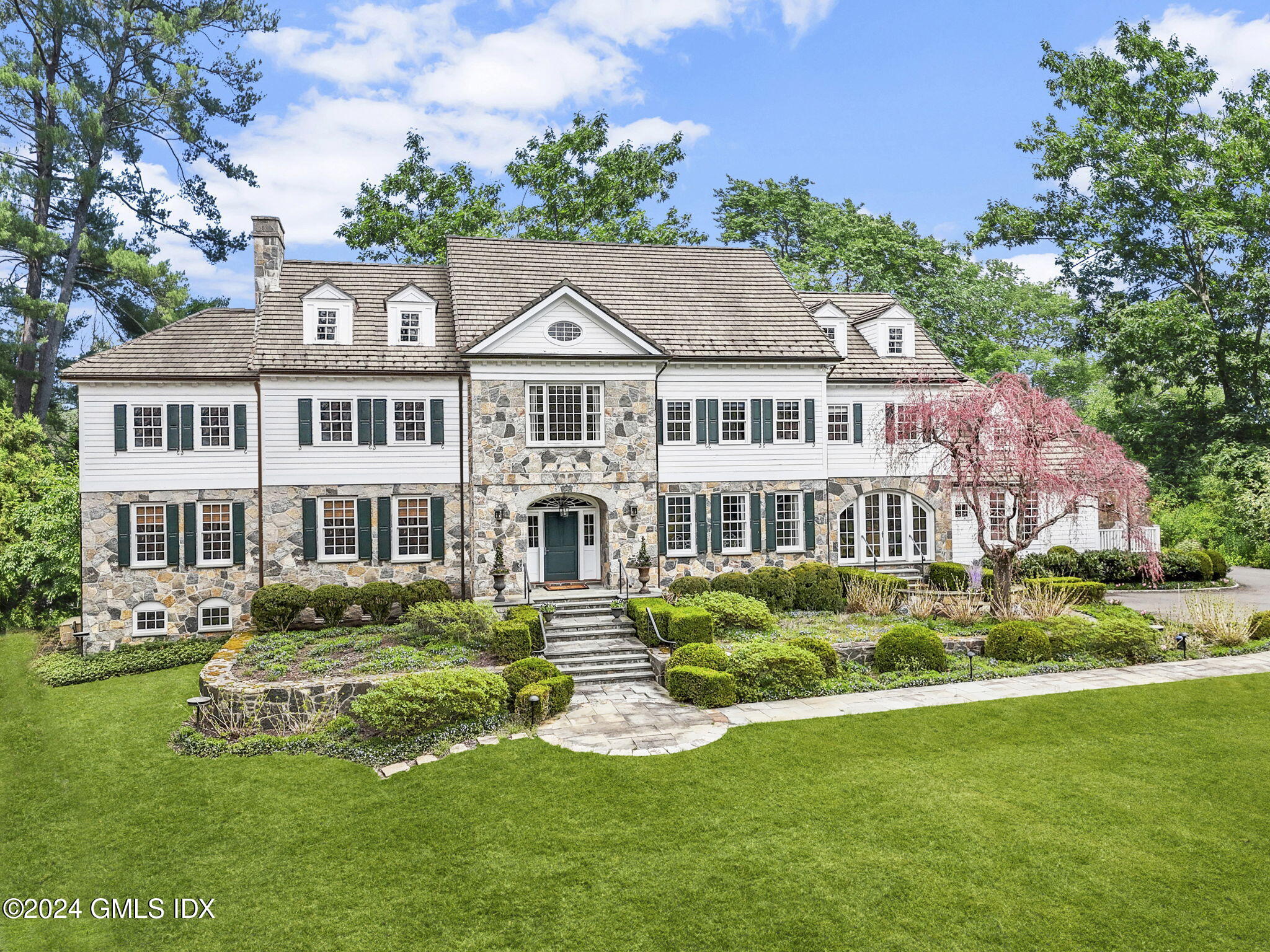68 Rock Maple Road Greenwich, CT 06830 - Photo 41 of 46 a front view of a house with a garden