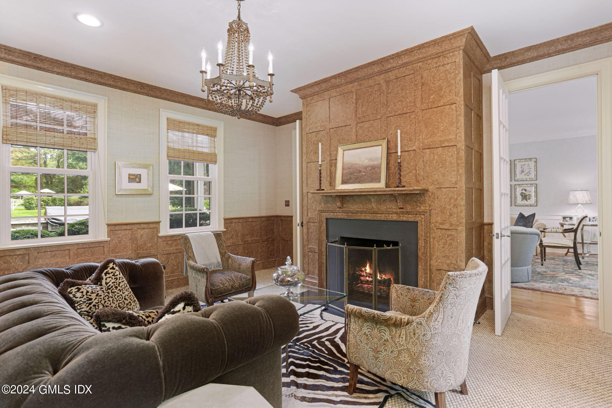 68 Rock Maple Road Greenwich, CT 06830 - Photo 7 of 46 a living room with furniture a chandelier and a fireplace