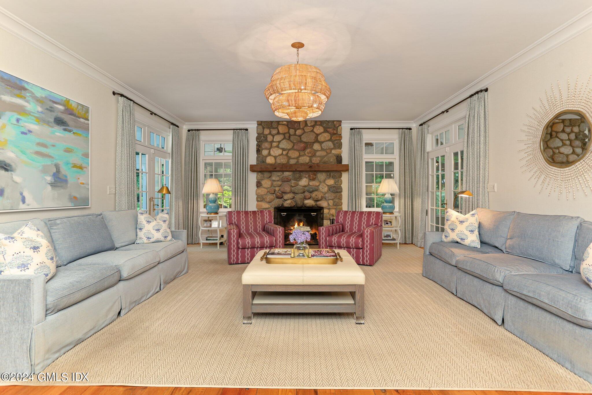 68 Rock Maple Road Greenwich, CT 06830 - Photo 9 of 46 a living room with furniture a fireplace and a chandelier