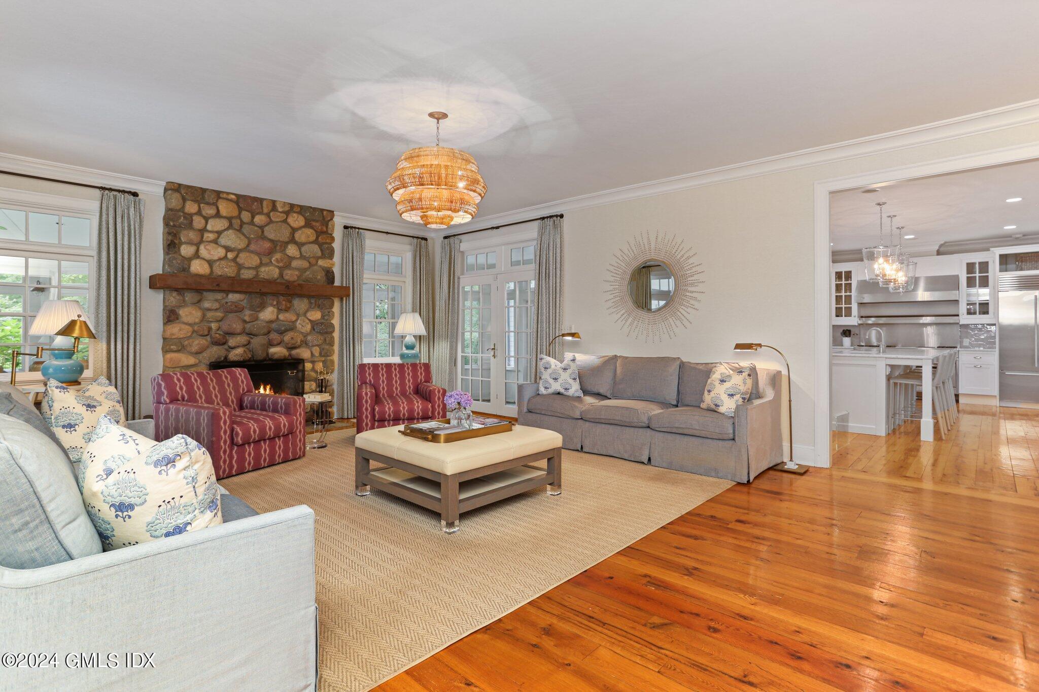 68 Rock Maple Road Greenwich, CT 06830 - Photo 10 of 46 a living room with fireplace furniture and a large window