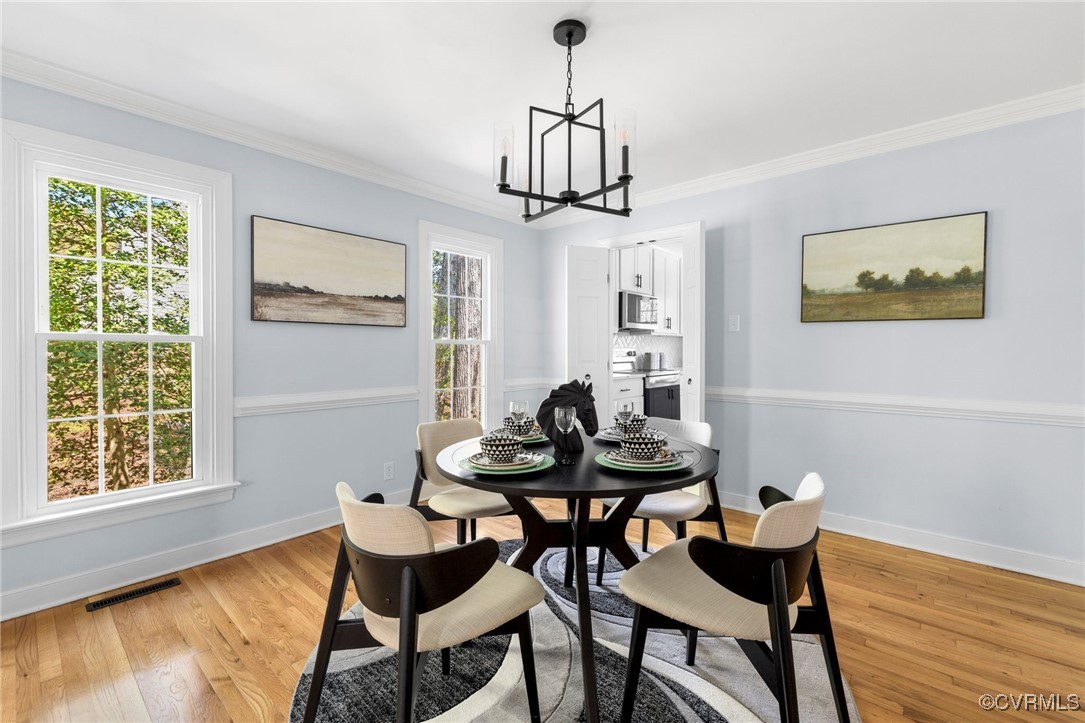 341 Rossmere Drive Midlothian, VA 23114 - Photo 9 of 41 a view of a dining room with furniture window and wooden floor
