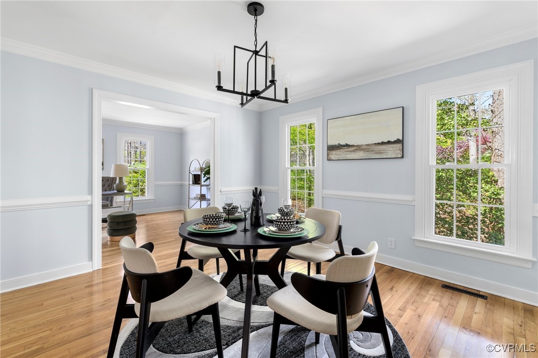 341 Rossmere Drive Midlothian, VA 23114 - Photo 10 of 41 a dining room with furniture a chandelier and wooden floor