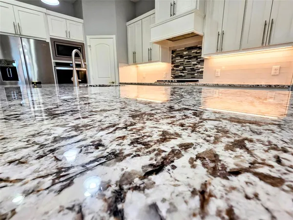 a kitchen with kitchen island a sink stainless steel appliances and cabinets