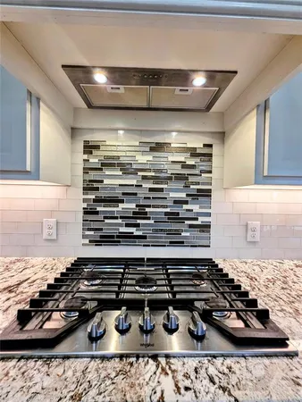 a kitchen with a stove and a refrigerator