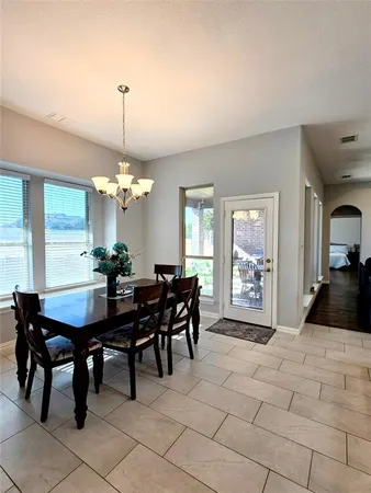 a view of a dining room with furniture and window
