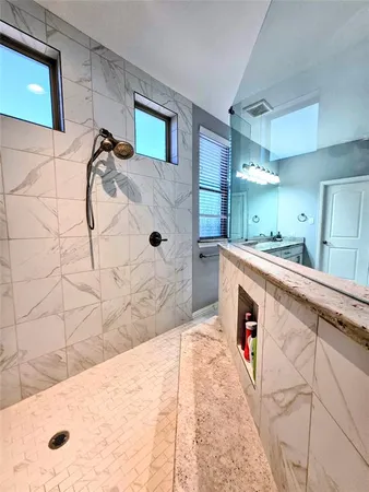 a bathroom with a tub sink and mirror