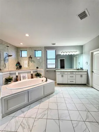 a large white room with a large mirror and sink