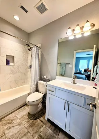 a bathroom with a sink toilet mirror and bathtub