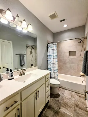 a bathroom with a double vanity sink toilet and shower
