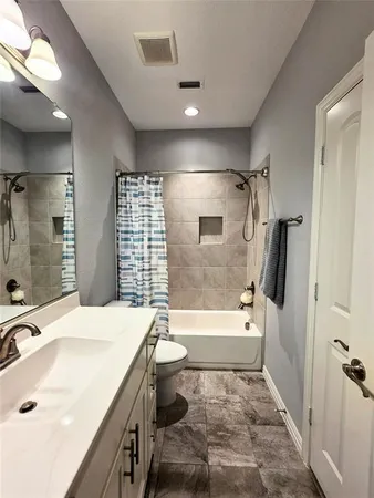 a bathroom with a sink toilet tub and shower