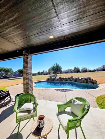 a view of a chairs and table in patio