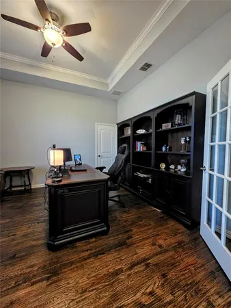 a living room with hard wood floors and a fireplace