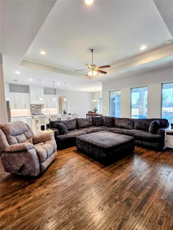 a living room with furniture and a wooden floor