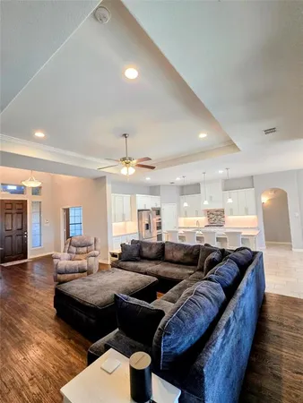 a living room with furniture and wooden floor
