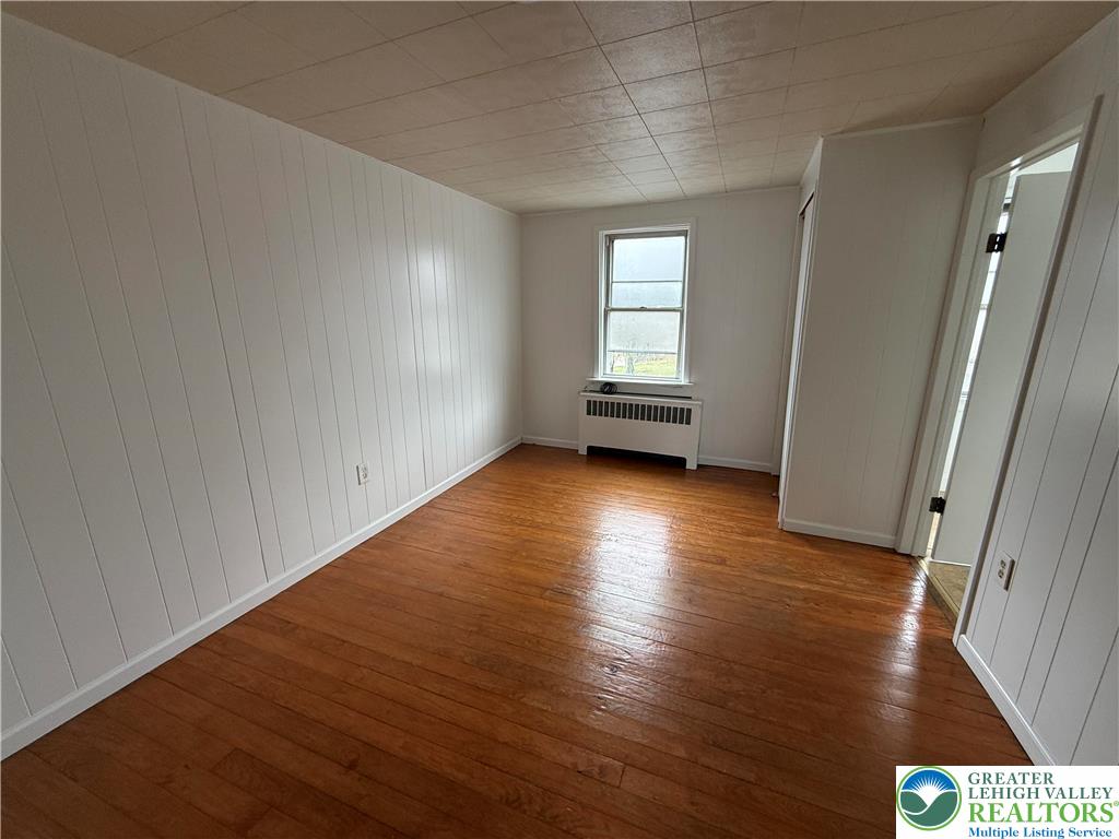 27 West Allen Street Allentown, PA 18102 - Photo 11 of 15 a view of an empty room with wooden floor and a window