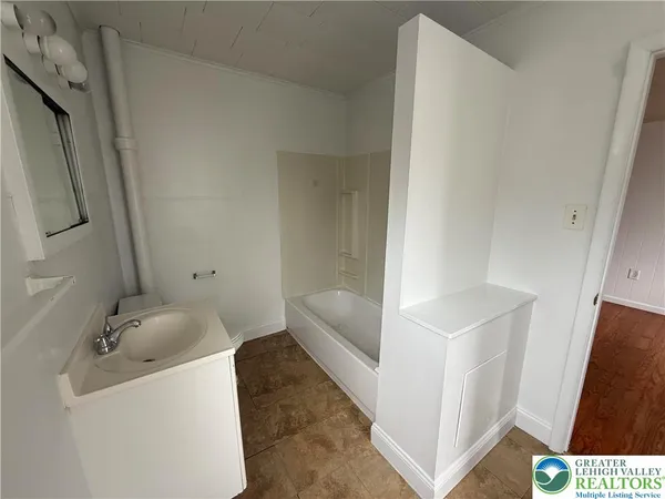 a bathroom with a sink and bathtub