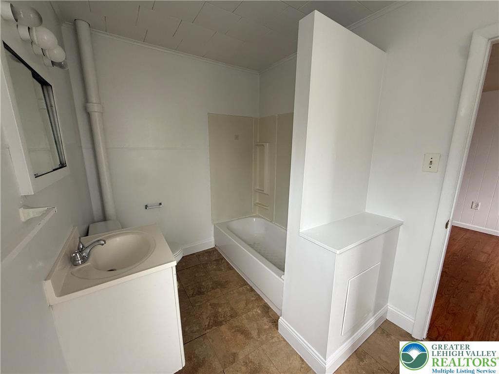 27 West Allen Street Allentown, PA 18102 - Photo 12 of 15 a bathroom with a sink and bathtub