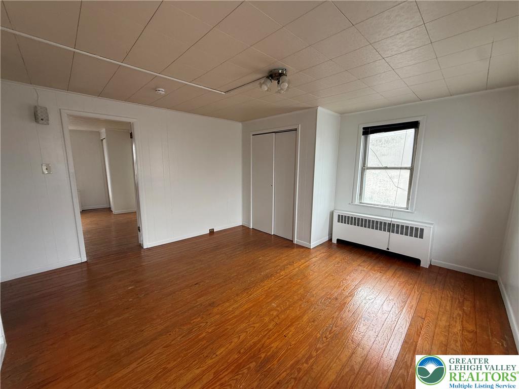 27 West Allen Street Allentown, PA 18102 - Photo 13 of 15 an empty room with wooden floor and windows