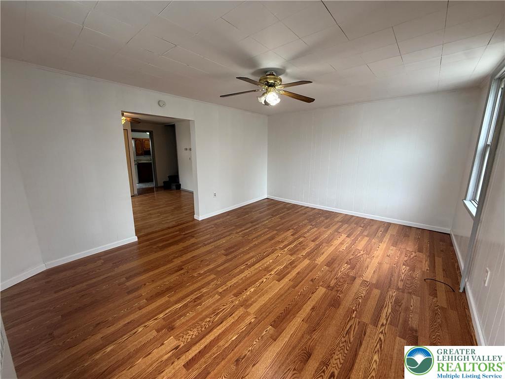 27 West Allen Street Allentown, PA 18102 - Photo 4 of 15 wooden floor in an empty room with a window
