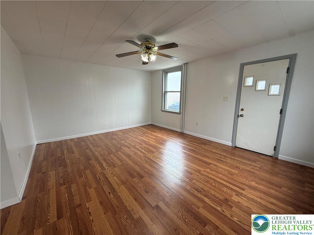 27 West Allen Street Allentown, PA 18102 - Photo 5 of 15 wooden floor in an empty room with a window