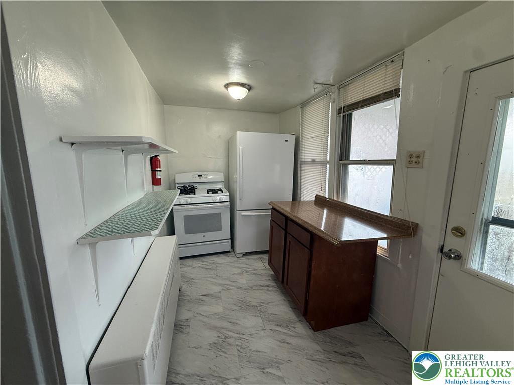 27 West Allen Street Allentown, PA 18102 - Photo 8 of 15 a kitchen with refrigerator cabinets and wooden floor
