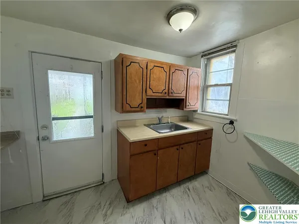 a kitchen with a stove sink and cabinets