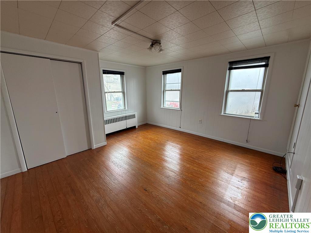 27 West Allen Street Allentown, PA 18102 - Photo 10 of 15 an empty room with wooden floor and windows