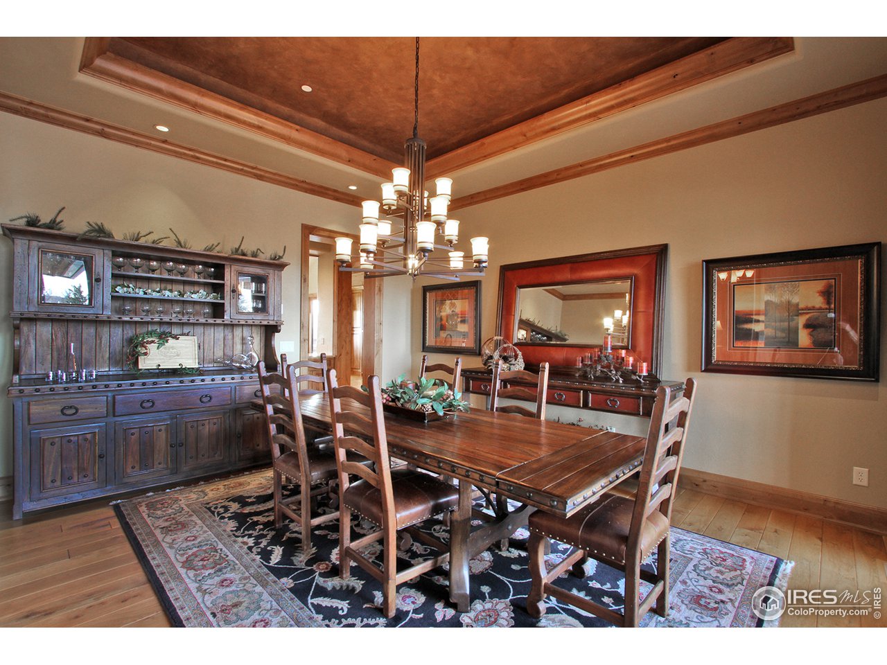 9455 Crystal Lane Longmont, CO 80503 - Photo 11 of 40 a dining room with wooden floor a chandelier a wooden table and chairs