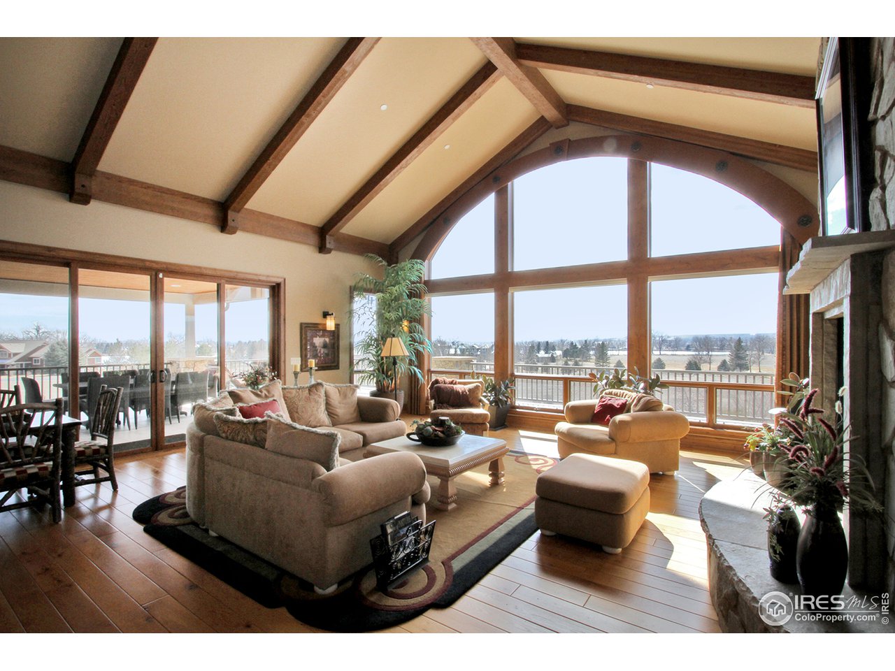 9455 Crystal Lane Longmont, CO 80503 - Photo 13 of 40 a living room with furniture tv and floor to ceiling windows
