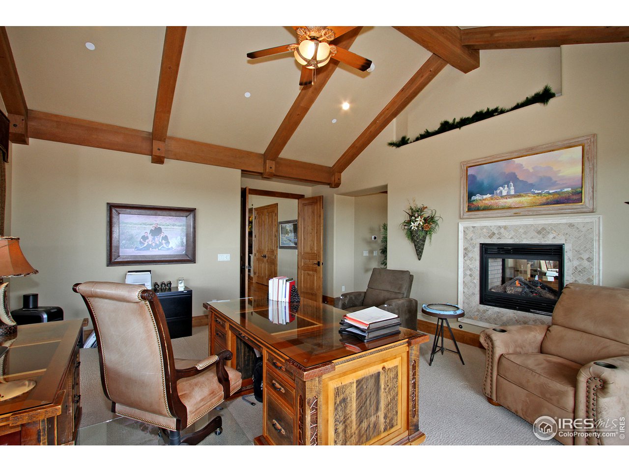 9455 Crystal Lane Longmont, CO 80503 - Photo 21 of 40 a living room with furniture a fireplace and a flat screen tv