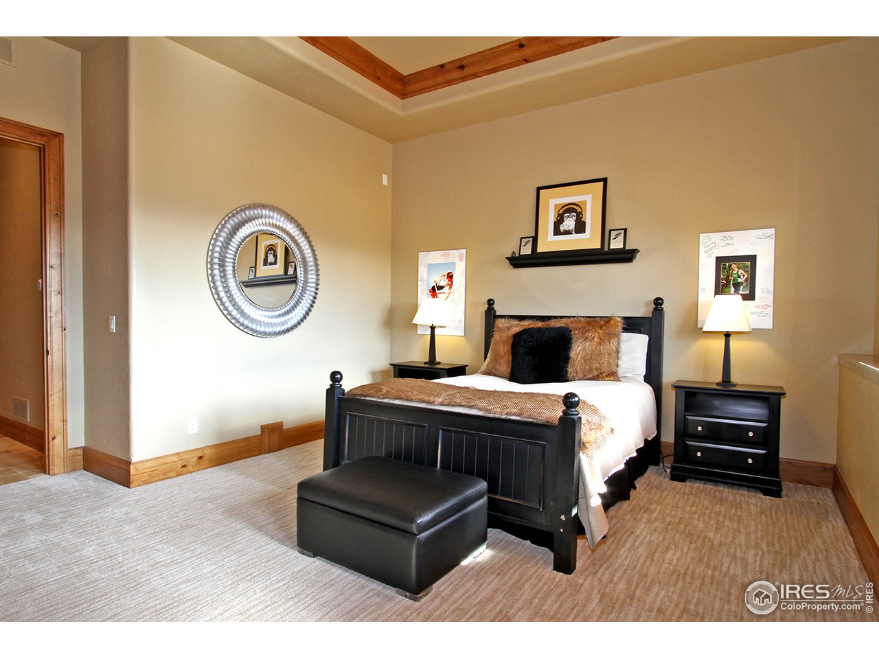 9455 Crystal Lane Longmont, CO 80503 - Photo 24 of 40 a bedroom with a bed and a chandelier