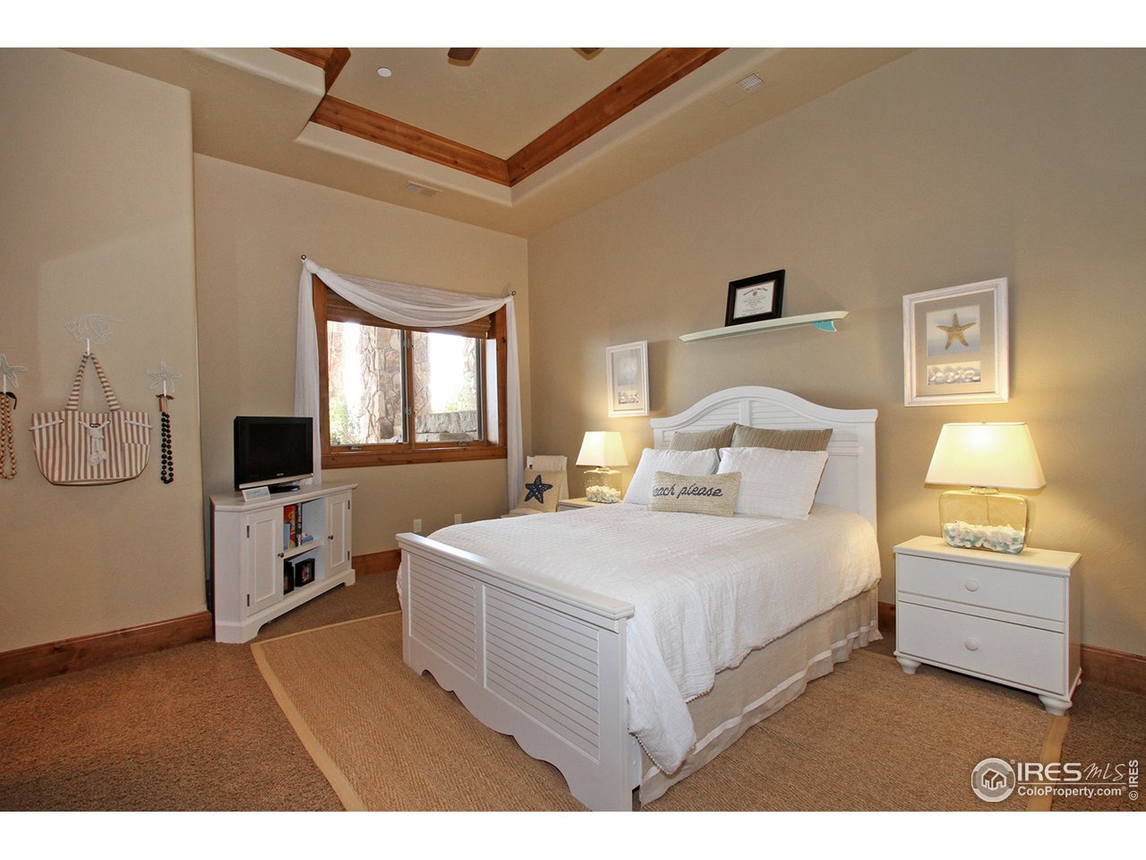 9455 Crystal Lane Longmont, CO 80503 - Photo 26 of 40 a bedroom with a bed and a flat screen tv