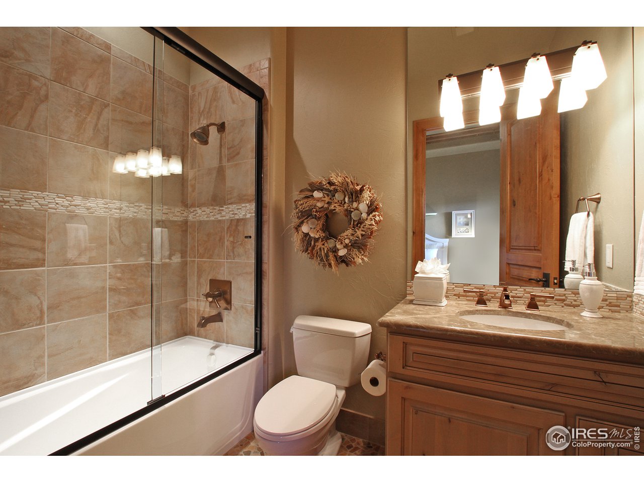 9455 Crystal Lane Longmont, CO 80503 - Photo 27 of 40 a bathroom with a sink a toilet and shower