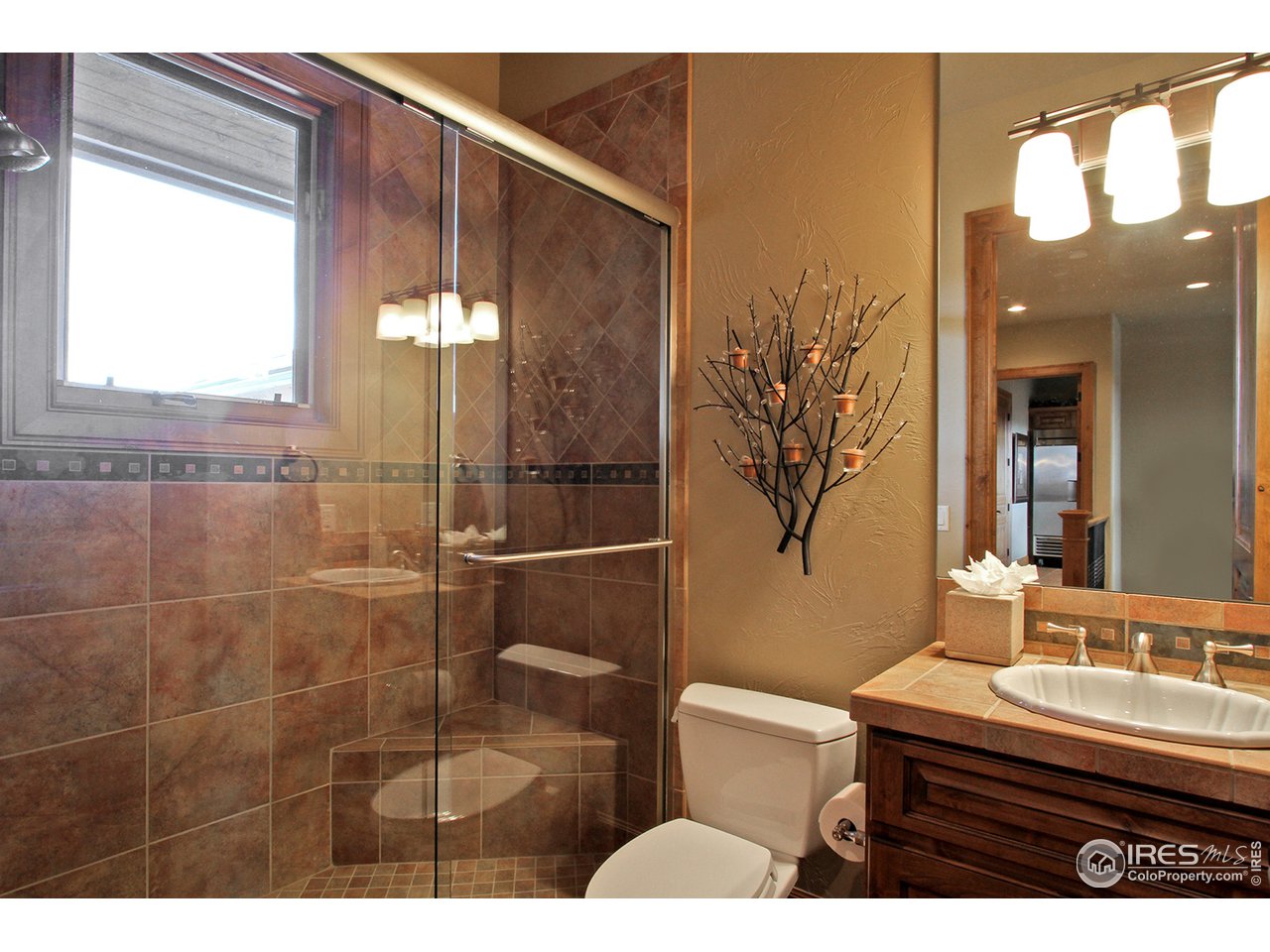 9455 Crystal Lane Longmont, CO 80503 - Photo 28 of 40 a bathroom with a sink a toilet and shower