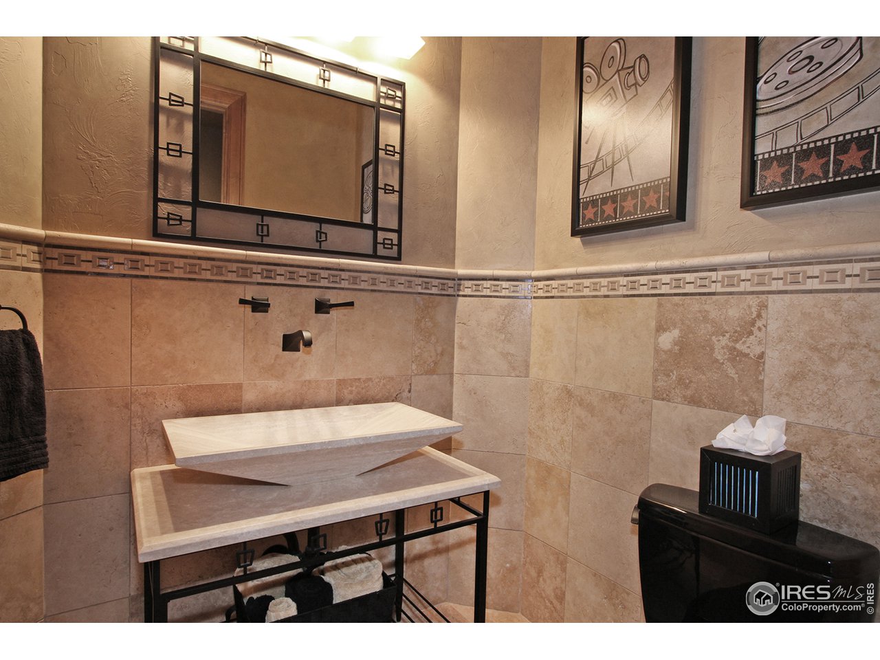 9455 Crystal Lane Longmont, CO 80503 - Photo 37 of 40 a bathroom with a sink a mirror and a toilet