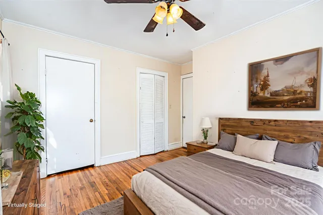 a bedroom with a large bed and a potted plant