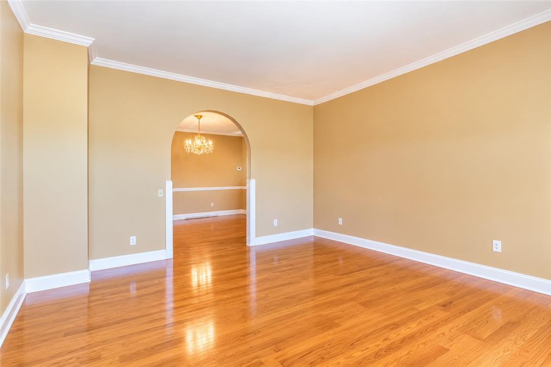 578 Daniels Road Nazareth, PA 18064 - Photo 20 of 45 Polished hardwood floors and classic crown molding frame a wide arched opening to the dining room.