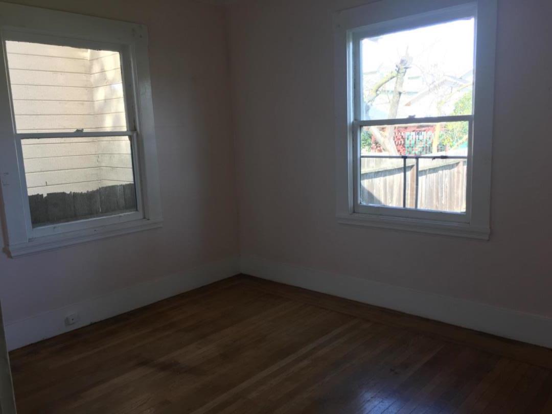 10 Bancroft Road Burlingame, CA 94010 - Photo 6 of 11 an empty room with wooden floor and windows