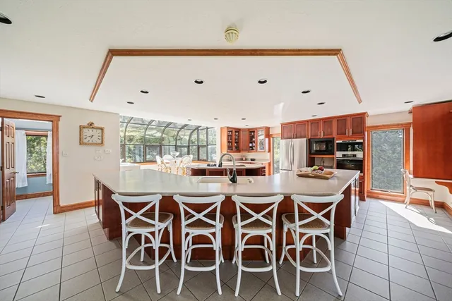 a dining room with furniture a chandelier and wooden floor